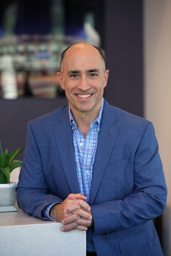 Dr. Goldman smiling in his office.